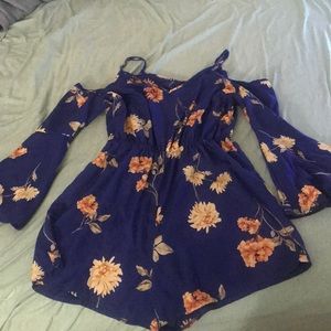 Blue romper with flowers on it.